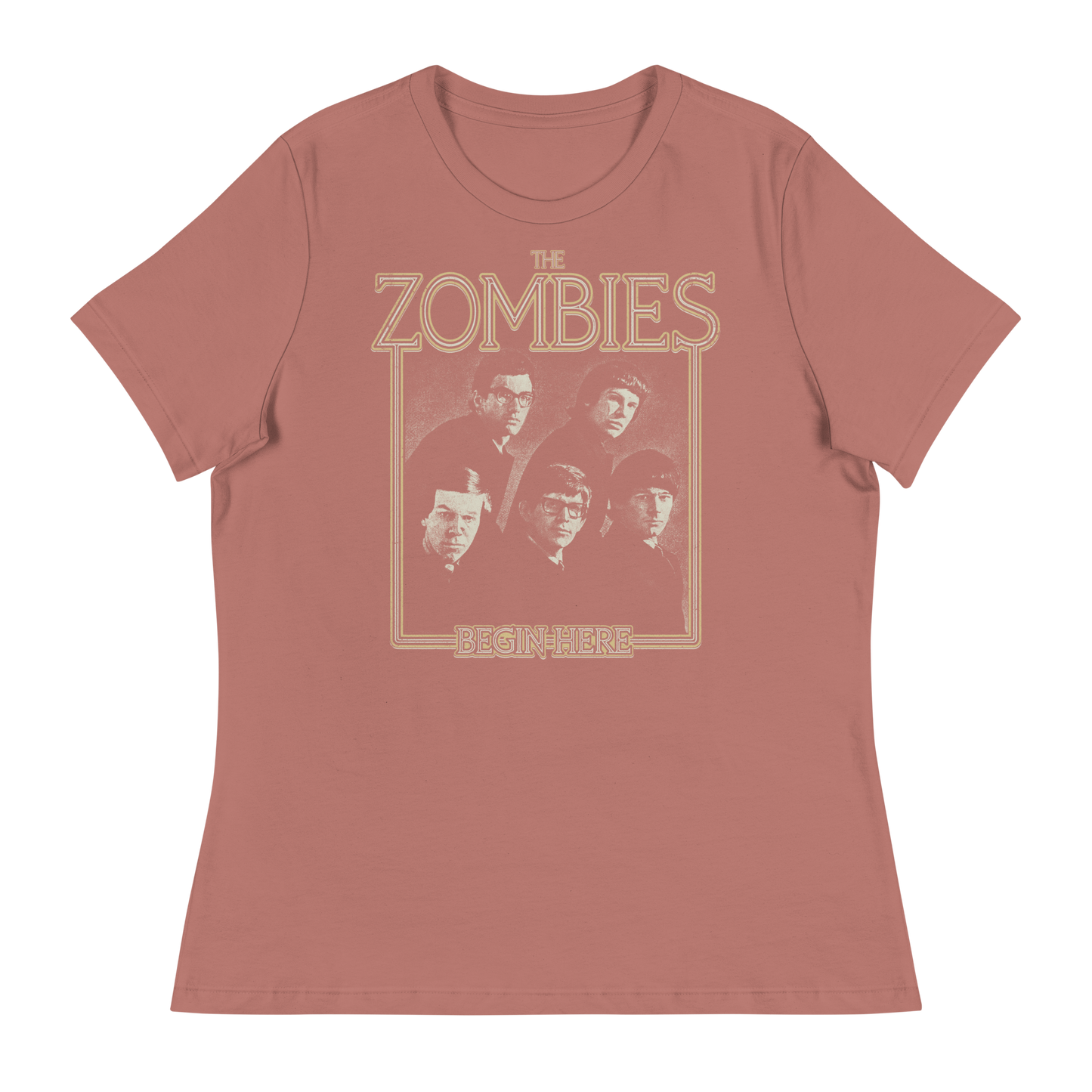 A dusty rose short-sleeve t-shirt with a vintage-style graphic of the band The Zombies and the text 'THE ZOMBIES' and 'BEGIN HERE' in a tan outline print.