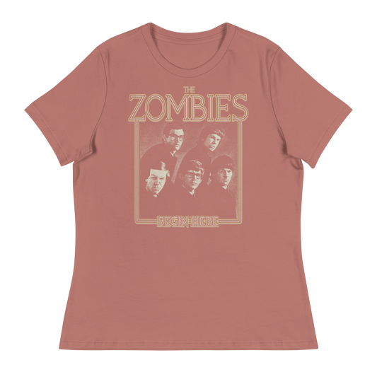 A dusty rose short-sleeve t-shirt with a vintage-style graphic of the band The Zombies and the text 'THE ZOMBIES' and 'BEGIN HERE' in a tan outline print.